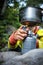 Female hiker/climber preparing supper on gas burner