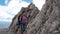 Female Hiker Climbing Rock on Mountain Peak Cliff