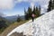 Female hiker crossing snow on mountain top