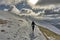 Female hiker descending a snow covered Helvellyn