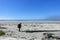 A female hiker exploring the sandy beaches of nels bight and experimental bight, surrounded by forest and the pacific ocean