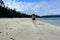 A female hiker exploring the sandy beaches of nels bight and experimental bight, surrounded by forest and the pacific ocean