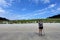 A female hiker exploring the sandy beaches of nels bight and experimental bight, surrounded by forest and the pacific ocean