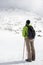 Female hiker gaze at mountain peak covered in snow