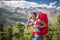 Female hiker in high mountains calling with her cell phone