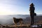 Female hiker and his dog looking horizon from ligurian apennines