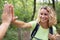 female hiker making high-five with companion