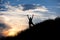 Female hiker silhouette with massive clouds on the