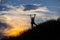 Female hiker silhouette with massive clouds on the