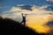 Female hiker silhouette with massive clouds on the