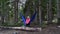 A Female Hiker sits in Hammock deep in the Wilderness