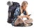 Female hiker sitting on the ground and looking at a cell phone