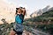 Female hiker standing in wild terrain looking on mountains