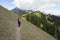 Female hiker on steep mountain ridge trail