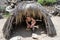 Female hiker takes shelter under a straw hut in the Indian Canyons of Palm Springs California while on a hike