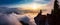 Female Hiker on top of a mountain covered in clouds