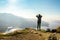 Female hiker on top of the mountain enjoying valley view