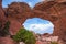 Female Hiker under Broken Arch, Arches National Park Moab Utah