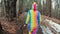 Female hiker in a unicorn costume in Autumn mountains forest