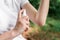 Female hiker using antiseptic spray outdoors