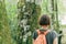 Female hiker walking on footpath through woods