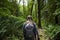 Female Hiker walking through a lush wooded forest in the beautiful Pacific Northwest.