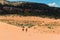 Female Hikers Crossing The Sand Dunes