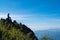 A female hiking and sitting on mountain peak, looking at a beautiful view