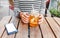 Female hipster student drinks a cool lemonade through a straw in a summer outdoor cafe