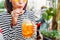 Female hipster student drinks a cool lemonade through a straw in a summer outdoor cafe