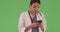 Female Hispanic medical professional texting on mobile cell phone green screen