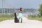 A Female Hitchhikes On A Dirt Road