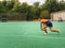 Female hockey player attacking and hitting on a grass field