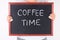 Female holding blackboard with chalk text Coffee Time