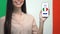 Female holding cellphone with learn Italian language app, modern online studying