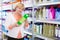 Female holding goods for cleaning house in shop