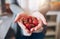 Female holding a handful of fresh strawberries