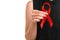 A female holding red ribbon isolated on a white background. Modern treatment and healthcare. AIDS awareness concept.