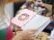 A female holding a trendy, original scratchpad for notes on a blurred background. A girl choosing a notepad in a store.