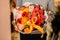 Female holds a bouquet with pion-shaped roses, poppies, pink and orange roses