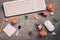 Female home office table desk. Workplace fashion blogger - keyboard, makeup cosmetics and coral rose flowers on a dark textured