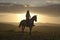 Female horseback rider and horse ride to overlook at Lewa Wildlife Conservancy in North Kenya, Africa at sunset