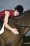 Female Horseback Rider Hugging Horse