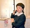 Female hotel administrator speaks on the phone in front of the counter