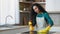 Female house cleaner pretty young mother housewife maid wears apron yellow rubber gloves splash detergent antibacterial