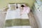 Female Housekeeper Arranging Bedsheet On Bed