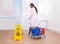 Female housekeeper cleaning floor in hotel