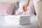 Female housekeeper putting flower onto clean towels on bed