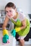 Female houseworker with rag and cleanser indoors