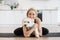 Female hugging small dog during yoga workout at home